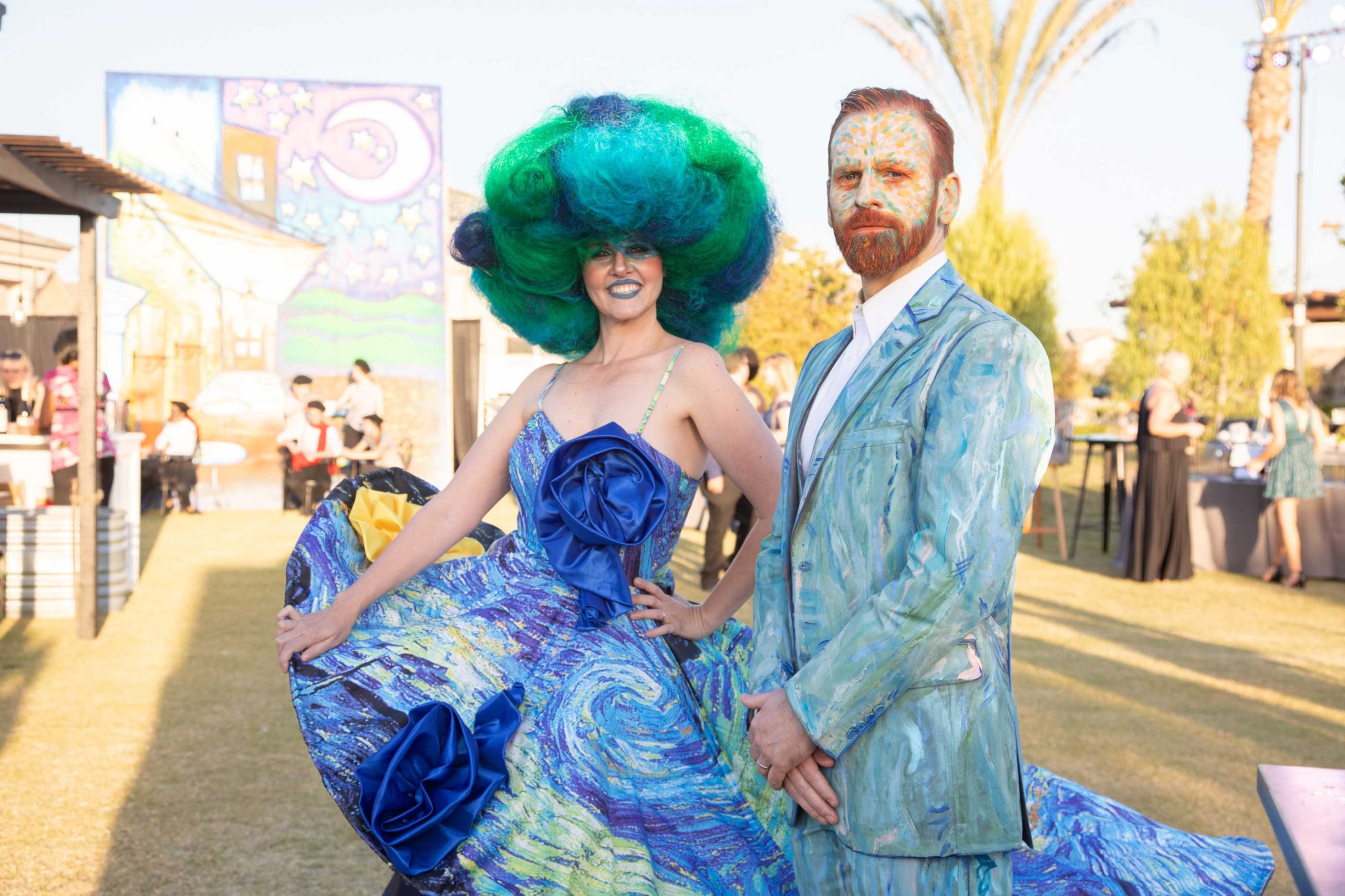 woman and man dressed in blues and greens with face paint
